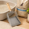 Stainless steel cat litter scoop with a wooden handle and fine mesh sifter resting on a wooden surface.