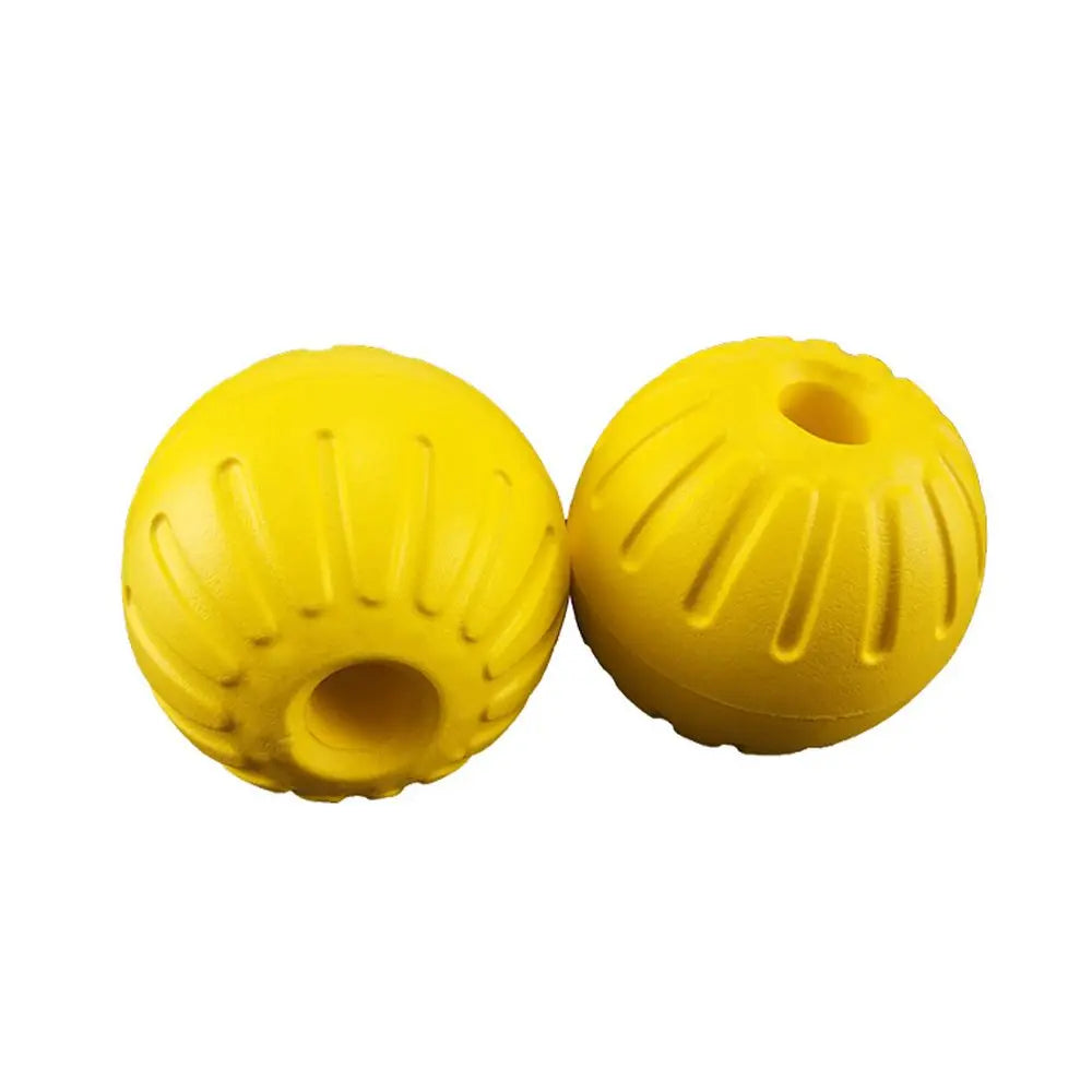 A bright yellow durable rubber fetch ball designed for dogs.