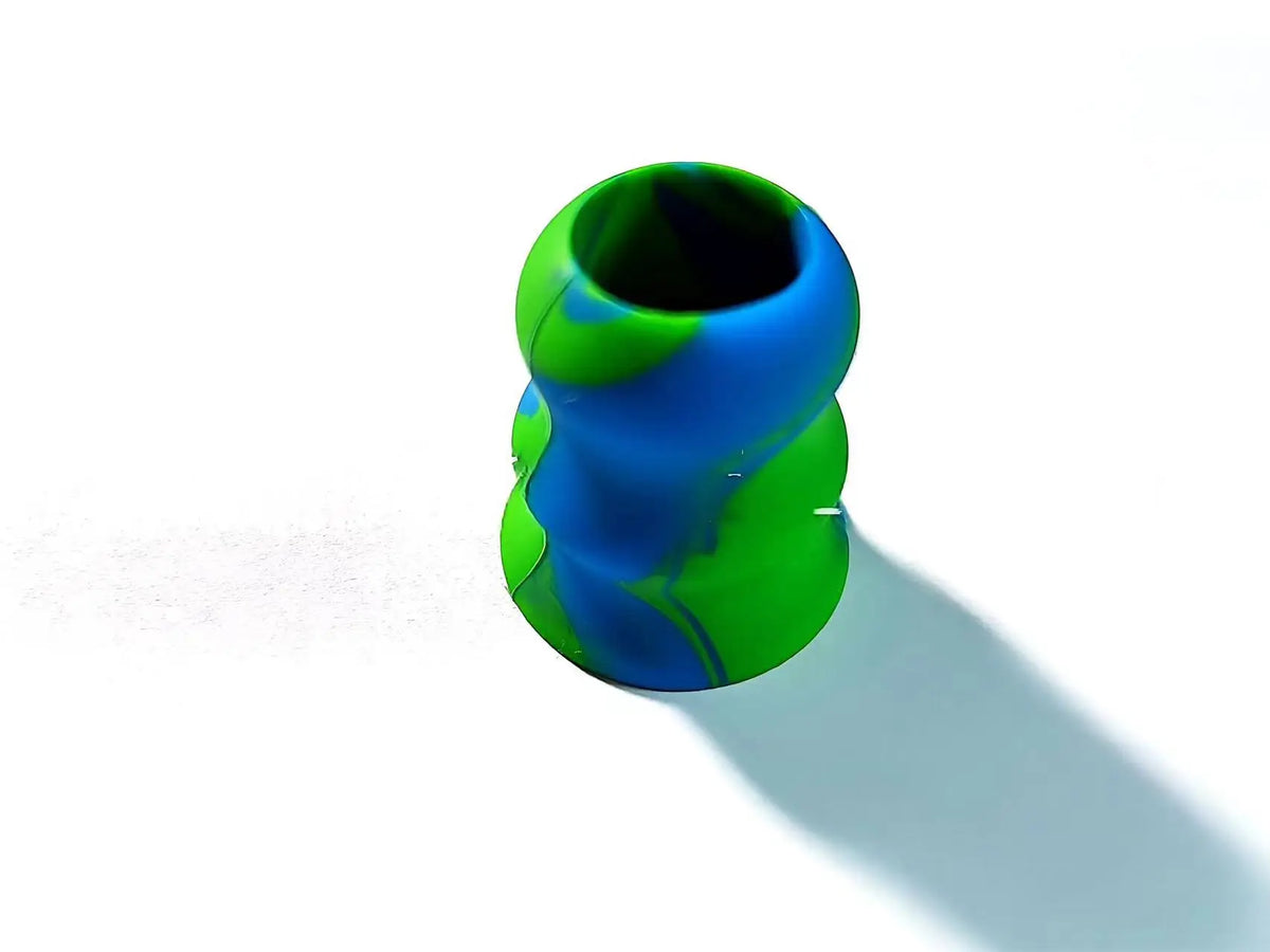 A close-up view of a silicone bat grip knob with a vibrant green and blue marbled pattern.