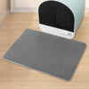 A gray double-layer cat litter mat is shown in front of a light green and black litter box.