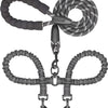 A black durable leather double dog leash with a shock absorbing bungee and metal clasps.