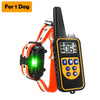 A black remote dog training collar with an LCD display and orange strap is shown.