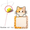 A wall-mounted cat scratcher featuring a large orange and white leopard print design with a yellow hanging toy.
