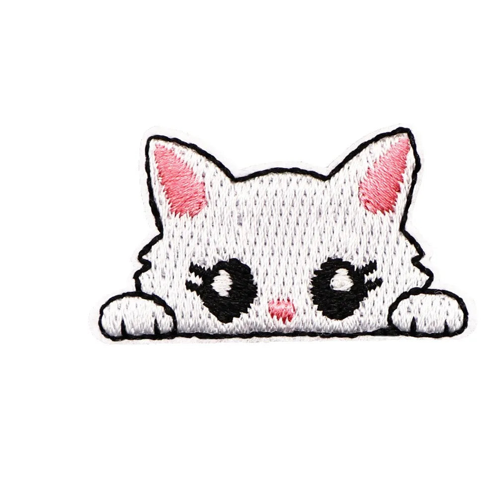 A cute embroidered cat patch featuring white fur and pink accents on a gray background.