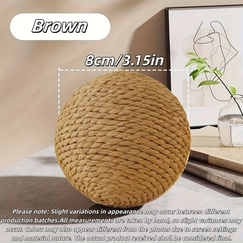 A brown sisal cat scratching ball is shown on a wooden surface.