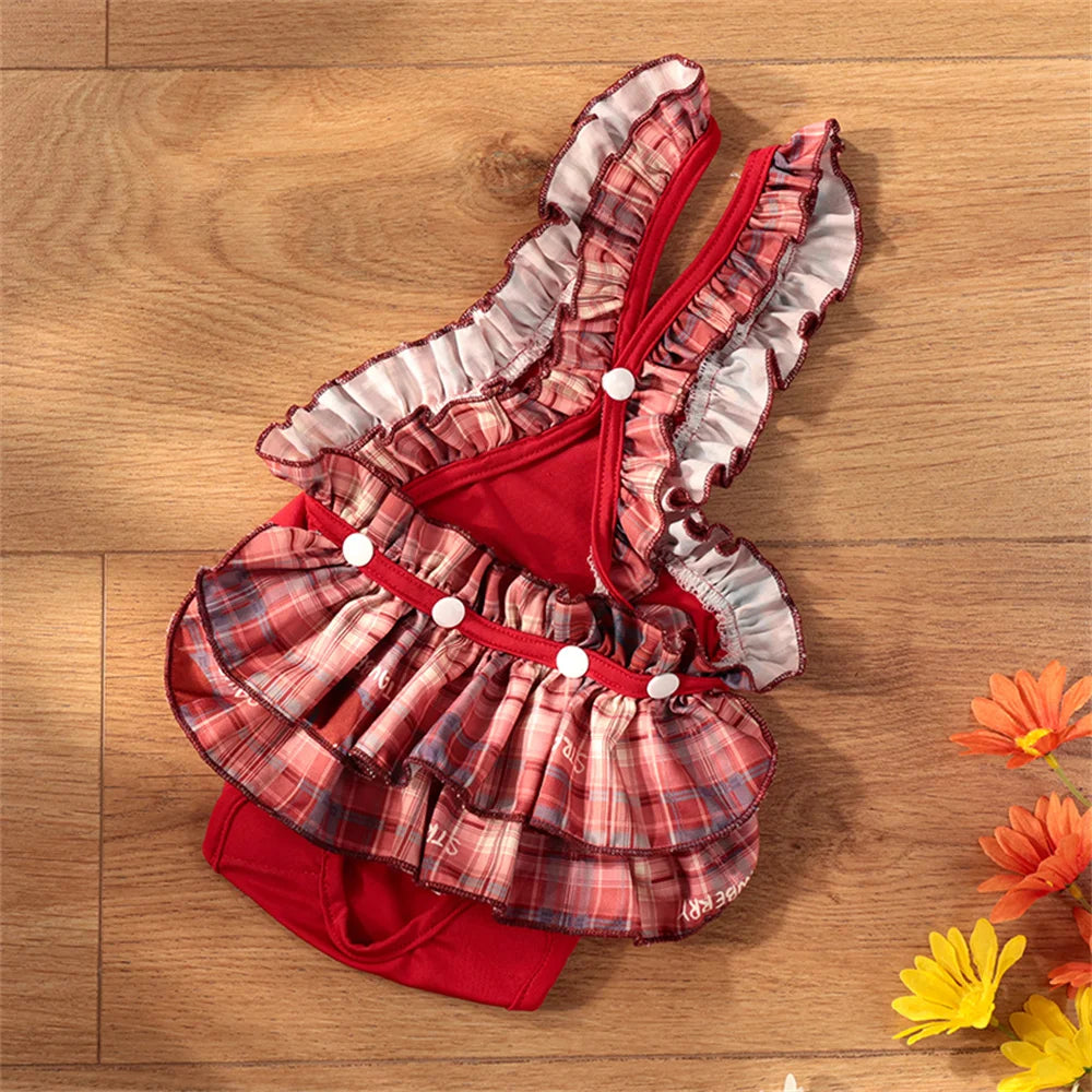 A stack of red and plaid reusable dog diaper pants with ruffled edges lying on a wooden surface.