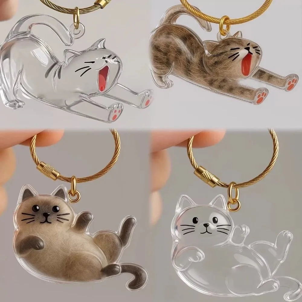 A collection of transparent and solid cat charms used as keychains, featuring various feline poses.