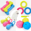 Assortment of colorful squeaky chew toys for dogs including pink, yellow, blue, and green rubber toys.