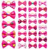 A collection of pink and yellow pet hair bows with gentle rubber bands.