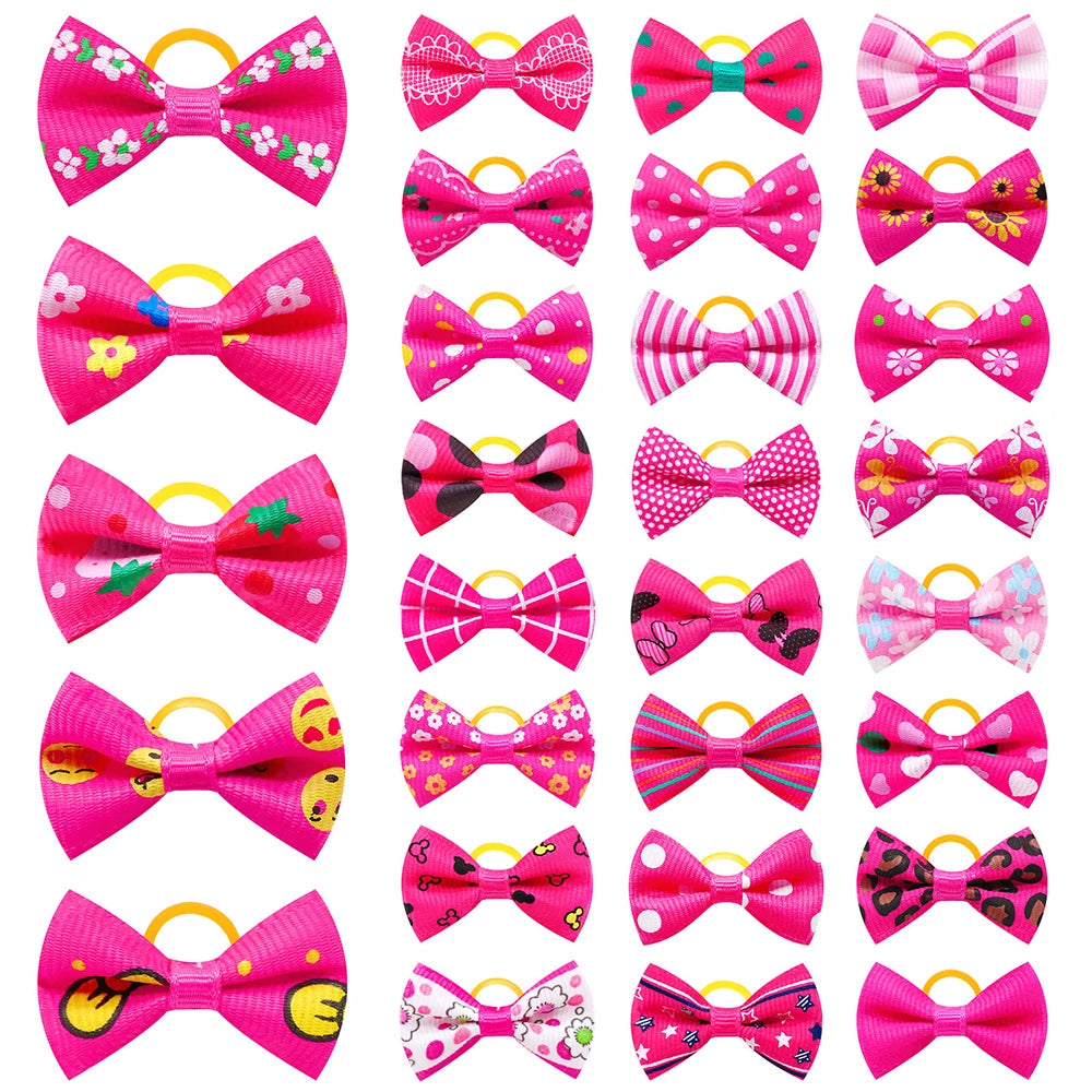 A collection of pink and yellow pet hair bows with gentle rubber bands.
