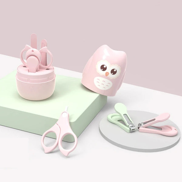 A pink kid-safe stainless steel nail care tool set featuring clippers and files on a light green surface.