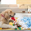 A golden retriever lies on a yellow mat with various toys and treats, demonstrating a dog sniffing mat for training.