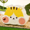 A white and yellow cartoon hamster hideout house with a viewing window is placed on a bed of light-colored wood shavings.