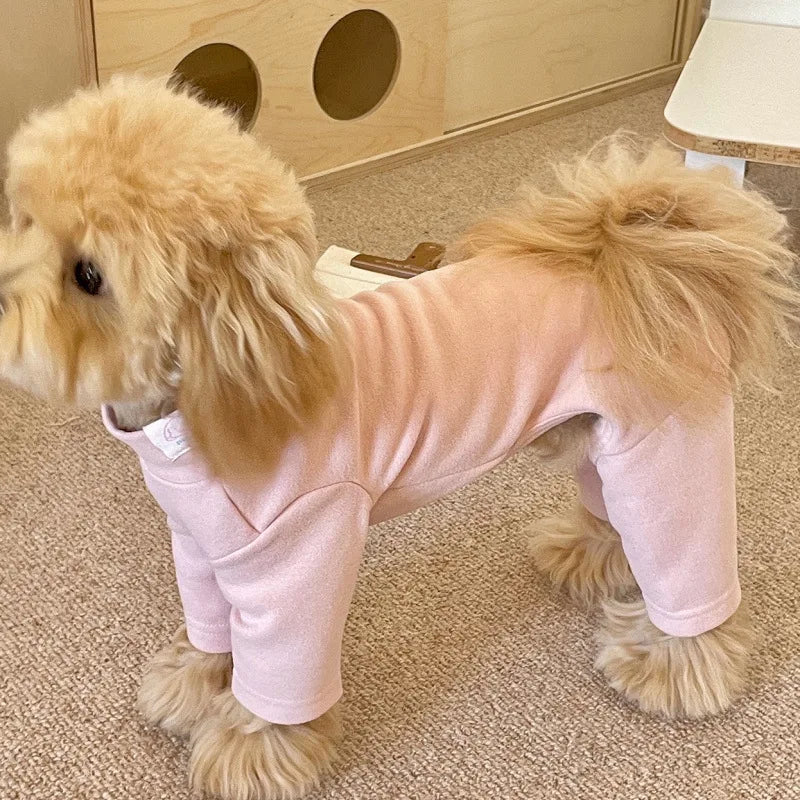 A light pink soft stretch dog pajama jumpsuit for a fluffy dog, shown in a side profile.