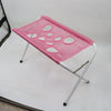 A pink pet grooming hammock for dog and cat restraint is displayed on a white surface.