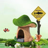 A resin aquarium house decor featuring a tree-like shelter with a warning sign and a small fox figurine.