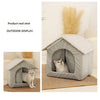 A gray folding pet house for a cat is displayed on a wooden floor.