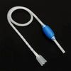 A white aquarium siphon gravel cleaner with a blue pump and tubing is shown against a black background.