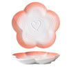 Bol à animaux en céramique blanche avec rebord et stries roses, montré sous deux angles.