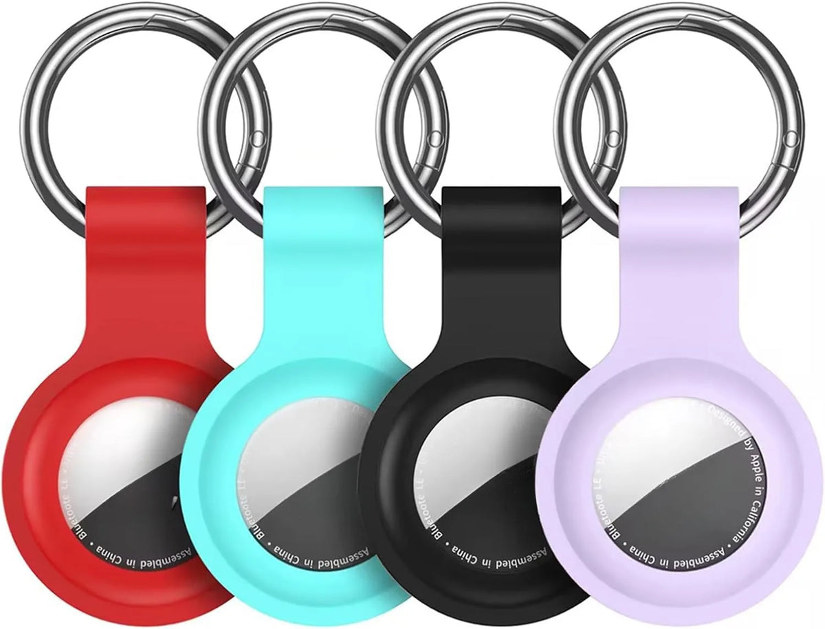 Silicone AirTag protective cover in red, cyan, black, and purple colors with a metal keychain ring.