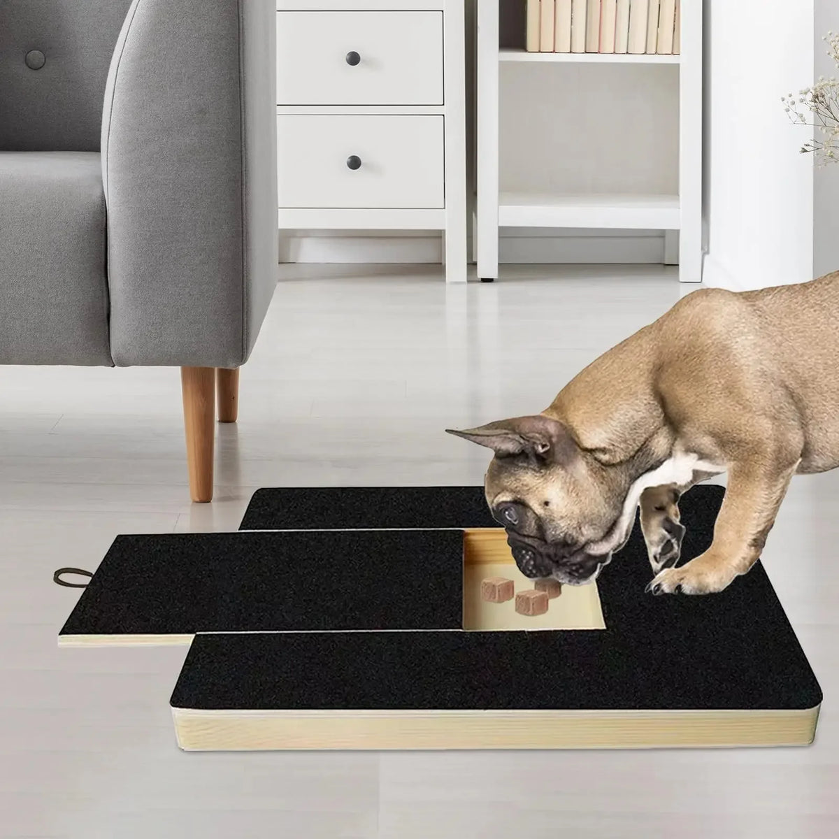 A wooden dog nail scratching board with an integrated treat box is placed on a light floor.