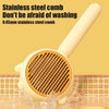 A yellow stainless steel comb used for pet hair removal, shown in water.