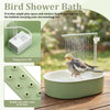 A bird shower bath setup showing a pump, a bowl of water, and a parrot bathing.