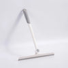 A white and gray 360° rotating shower squeegee with a silicone holder mounted on a flat base.