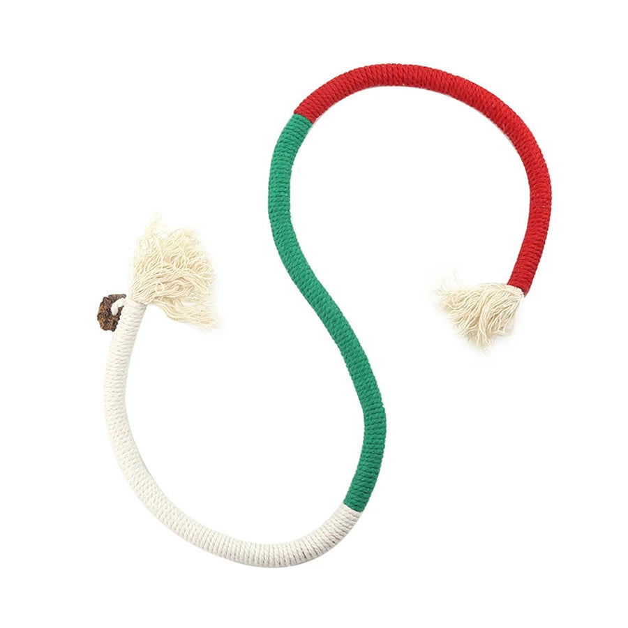 A loop of rope toy for cats with red and green sections and fluffy white ends.