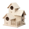 A light wood birdhouse with a pitched roof and decorative slats, designed for garden or patio use.