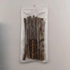 A clear plastic bag contains several natural herbal cat chew sticks.