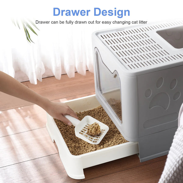 A hand is drawing out the drawer of a white cat litter box, showing its design for easy changing.
