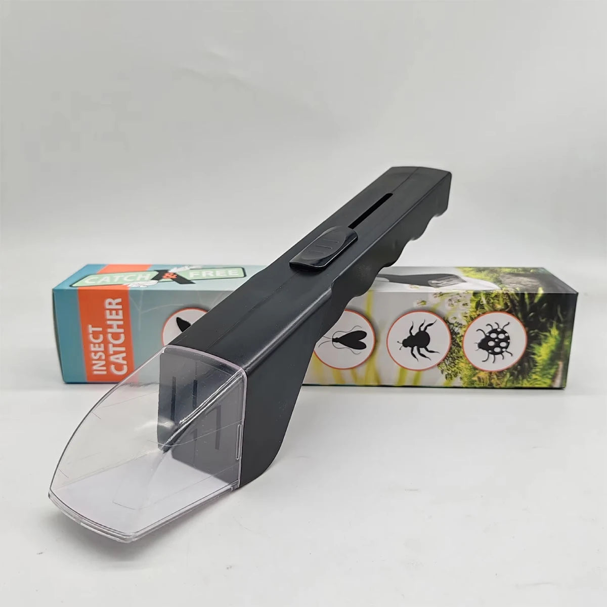 A black portable handheld insect catcher with a clear plastic collection chamber is displayed next to its packaging.