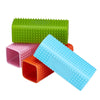 A set of silicone pet hair removal brushes in green, pink, and blue.