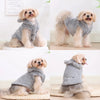 A fluffy light gray fleece hoodie for a small dog sitting on a white surface.