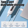 A Type-C port used while charging cable connected to a device on a blue surface.