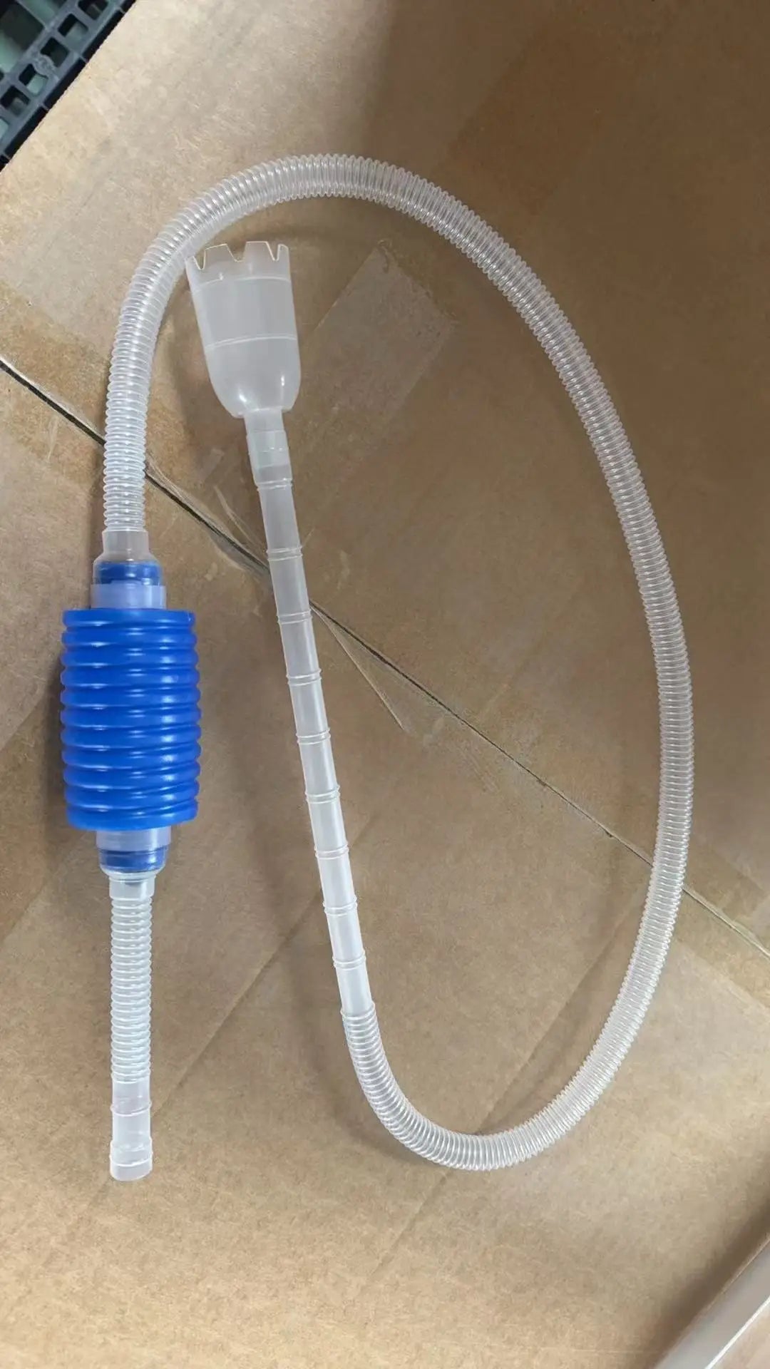 A clear plastic siphon pump and tubing assembly with a blue silicone adapter for aquarium gravel cleaning.