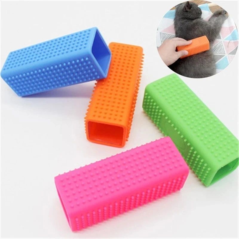 A collection of silicone pet hair remover brushes in blue, orange, green, and pink, with a cat's paw visible.