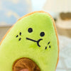 A bright green avocado plush toy with orange accents, showing a cute, slightly sad expression.