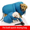 A blue foldable pet bath drying bag filled with a golden-colored dog is shown.