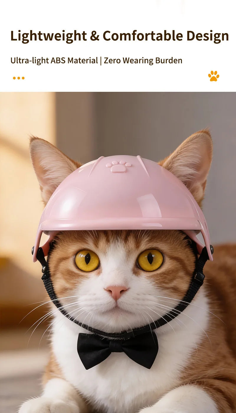 Un gato doméstico vistiendo un casco de seguridad rosa con correas negras y una pajarita negra.