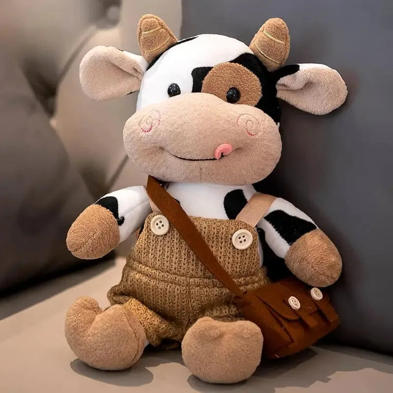 A white and black cow plush toy with brown accents, sitting on a light surface.