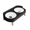 Black stainless steel double bowl for dogs and cats with two white bowls on a wooden stand