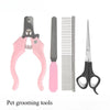 A set of pink pet grooming tools including a clipper, comb, and scissors.