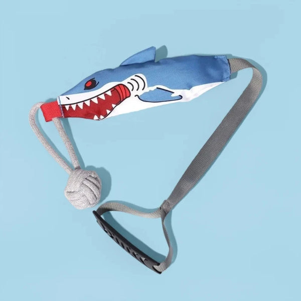 A blue and white shark-themed dog tug-of-war rope toy with a gray strap and a knotted end.