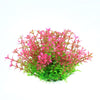 A cluster of vibrant pink and green artificial aquarium plants.