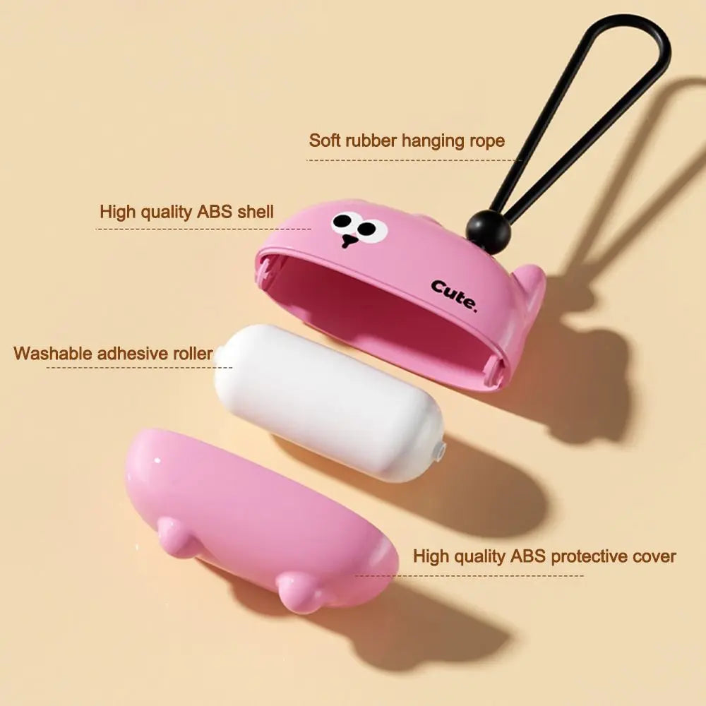 Pink reusable pet hair roller with a hanging rope and adhesive roller component.