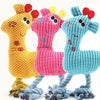 Three knitted plush toys shaped like giraffes in yellow, pink, and blue with dangling feet
