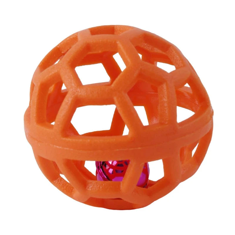 An orange, honeycomb-patterned rubber dog chew ball with a pink bell inside.