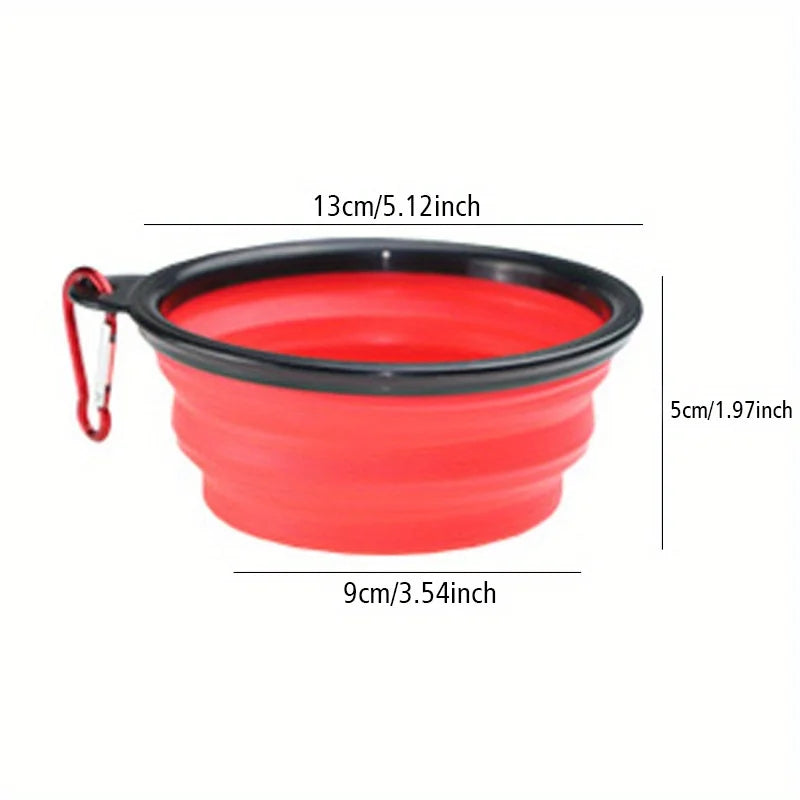 A bright red silicone dog travel bowl with a black rim and handle, shown from above.
